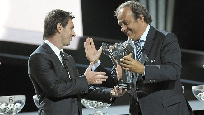 Lionel Messi receives his award from UEFA President Michel Platini