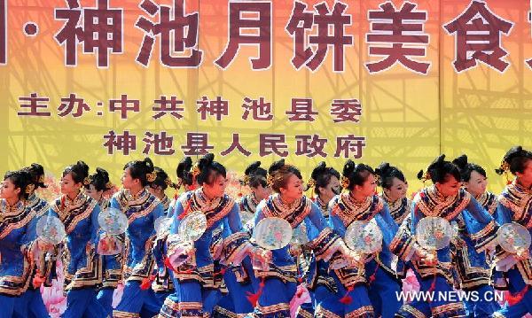 Dancers perform during a moon cake feast in Shenchi, north China's Shanxi Province, Aug. 23, 2011. 