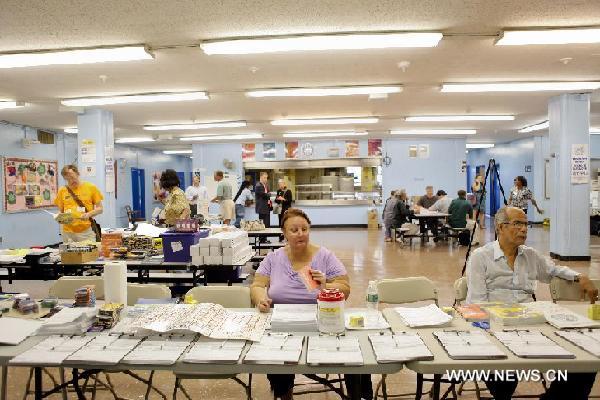 Workers prepare for the upcoming Hurricane Irene in a public-school-turned shelter in Brooklyn, New York, the United States, Aug. 26, 2011. Shelters like this will provide people with supplies and a safe place to rest during the upcoming hurricane. New York City Mayor Michael Bloomberg announced Friday that mandatory evacuations have been ordered for residents living in the low-lying areas of the city. [Fan Xia/Xinhua]