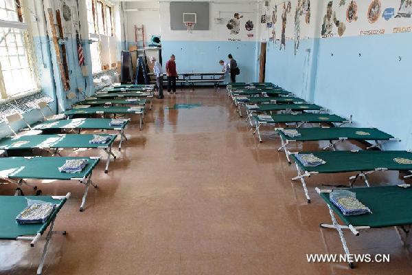 Public School 187 is seen as it is turned into a shelter for the upcoming Hurricane Irene, in Brooklyn, New York, the United States, Aug. 26, 2011. Shelters like this will provide people with supplies and a safe place to rest during the upcoming hurricane. New York City Mayor Michael Bloomberg announced Friday that mandatory evacuations have been ordered for residents living in the low-lying areas of the city. [Fan Xia/Xinhua] 