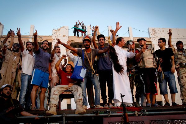 Libyan rebel fighters enter the Bab al-Azizya compound, the main stronghold of Gaddafi, in Tripoli, Libya, on August, 23 2011.