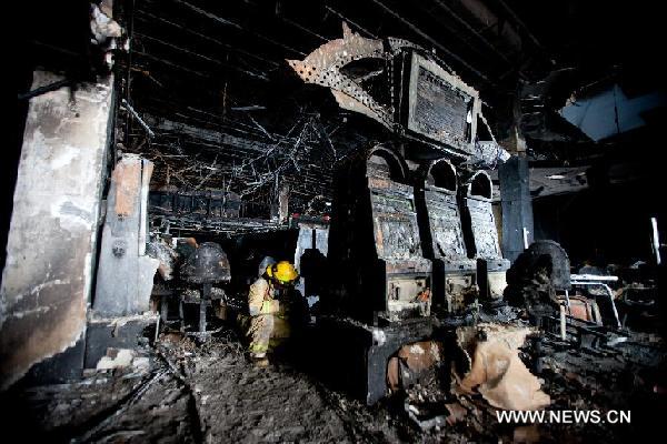 A fireman works inside the damaged Casino Royale in Monterrey, Mexico, Aug. 26, 2011. An armed group broke into the packed Casino Royale, sprayed fuel and set fire, killing at least 53 people and leaving dozens of others injured on Thursday afternoon. [Xinhua/Pedro Mera] 