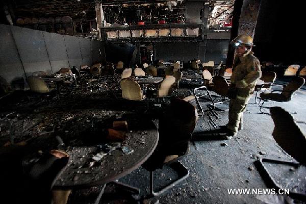 A fireman walks inside the damaged Casino Royale in Monterrey, Mexico, Aug. 26, 2011. An armed group broke into the packed Casino Royale, sprayed fuel and set fire, killing at least 53 people and leaving dozens of others injured on Thursday afternoon. [Xinhua/Pedro Mera] 