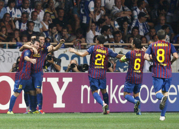 Barcelona's Lionel Messi (L) celebrates his goal against Porto with teammates during their European Super Cup soccer match at Louis II stadium in Monaco August 26, 2011. [Xinhua/Reuters Photo]