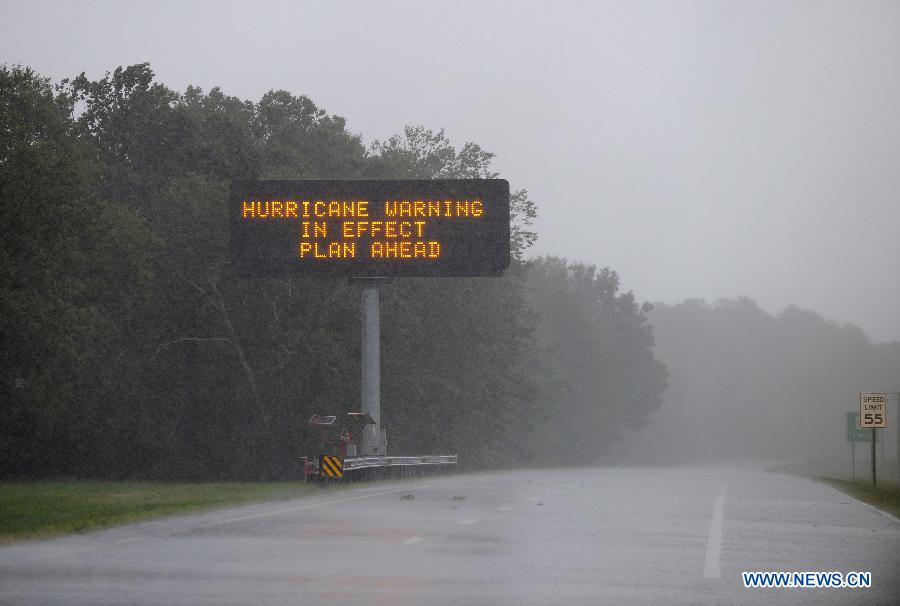 Photo taken on Aug. 27 shows the warning sign of Hurricane Irene outside the Ocean City, Maryland, the United States. The Hurricane Irene hits the Ocean City of Maryland on Saturday. [Zhang Jun/Xinhua]