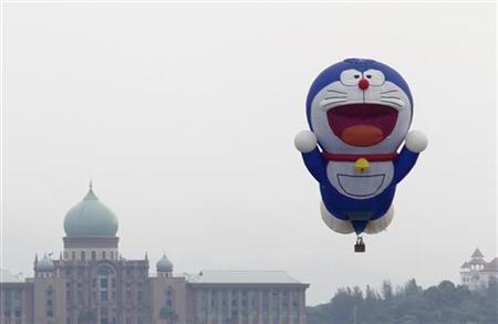 The ''Doraemon'' hot air balloon piloted by Hedaaki Ito of Japan floats over Malaysia's landmark Putra Perdana, the office of the Prime Minister, in the capital of Putrajaya outside Kuala Lumpur March 17, 2011. [Reuters]