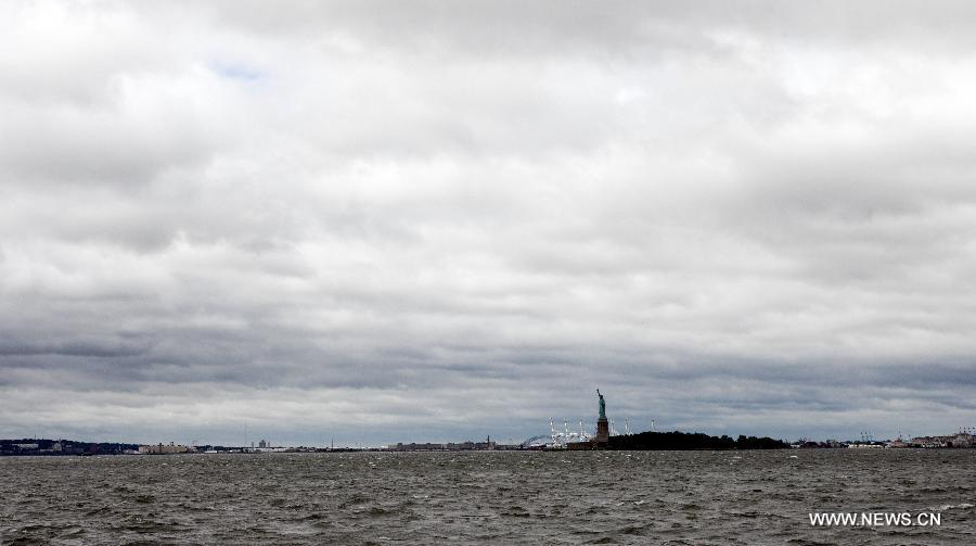 The Statue of Liberty is seen at New York Harbor in New York, the United States, Aug. 28, 2011. U.S. Homeland Security Secretary Janet Napolitano said on Sunday that the worst of Hurricane Irene was over but communities still in Irene's path should continue to be vigilant. It lost some strength as it hit the New York City Sunday morning.