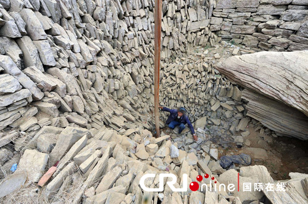 A farmer checks the bottom of a dried well in Leizhuang village in Guizhou province on Saturday. Severe drought has dried up 479 reservoirs and 349 rivers in the province, leaving more than 5.47 million people short of drinking water.