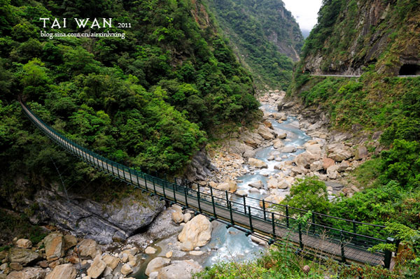 A bridge spans a rushing creek.