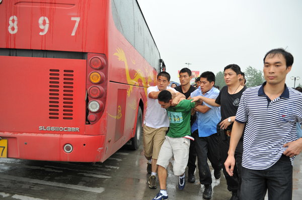 A man is arrested on the on the highway of Nanjing's Third Yangtze River Bridge after a bus hijacking incident in Nanjing, East China's Jiangsu province, Aug 30, 2011.