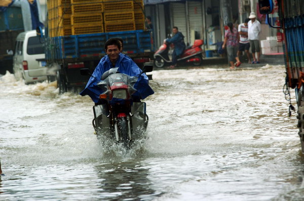 Rainwater brought by tropical storm Nanmadol flooded the streets of Baishuiwan village, Anji county, east China's Zhejiang Province, Aug 30, 2011. 