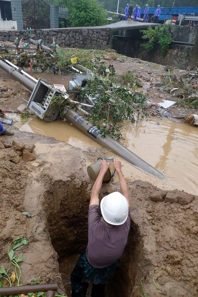 The storm knocked down some utility poles in Xiaquan village, Anji county, Zhejiang Province, Aug 30, 2011. 