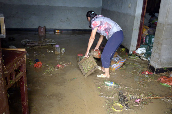 Floods brought garbage into some homes in Qingshan village, Anji county, Zhejiang Province, Aug 30, 2011. 