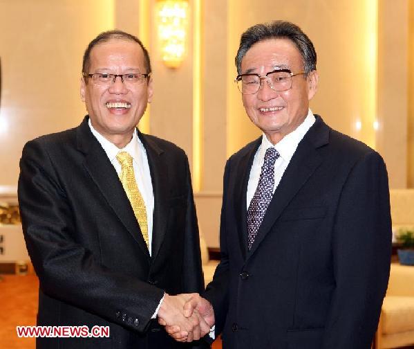 Wu Bangguo (R), chairman of the Standing Committee of the National People's Congress of China, shakes hands with Philippine President Benigno Aquino III in Beijing, capital of China, Sept. 1, 2011. [Yao Dawei/Xinhua]