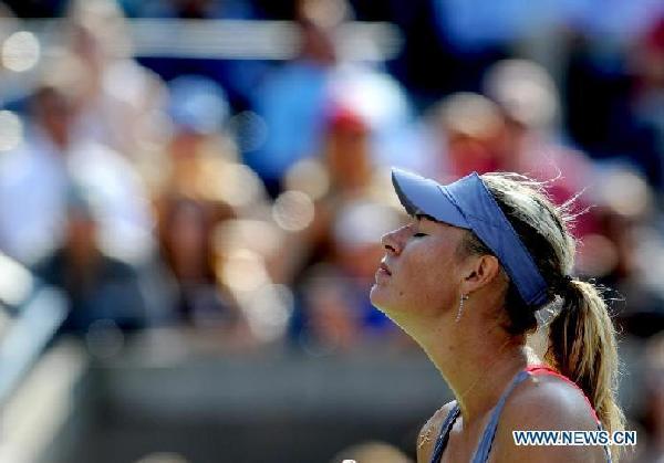 Maria Sharapova of Russia reacts during the match against Flavia Pennetta of Italy at the US Open tennis tournament in New York Sept. 2, 2011. Flavia Pennetta won 2-1. [Shen Hong/Xinhua] 