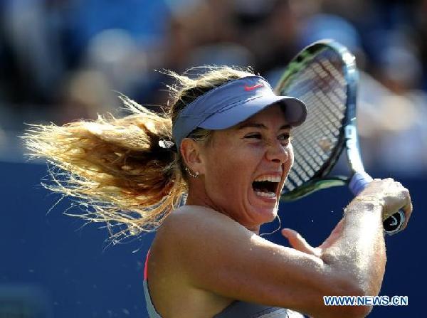 Maria Sharapova of Russia returns a shot during the match against Flavia Pennetta of Italy at the US Open tennis tournament in New York Sept. 2, 2011. Flavia Pennetta won 2-1. [Shen Hong/Xinhua]