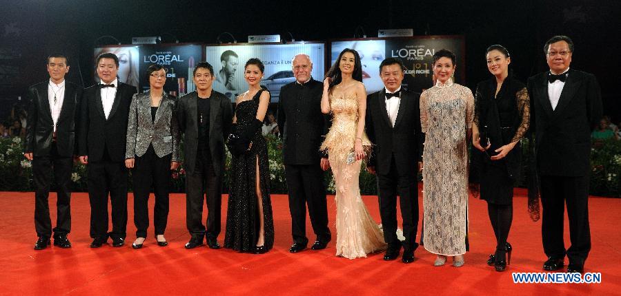 Creators, cast members and guests pose on the red carpet for the premiere of the Chinese Hong Kong film 'Bai She Chuan Shuo' ('The Sorcerer and the White Snake') at the 68th Venice International Film Festival in Venice, Italy, Sept. 2, 2011. [Wang Qingqin/Xinhua]