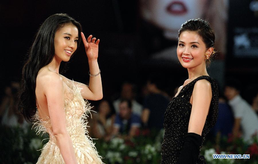 Actresses Eva Huang (L) and Charlene Choi pose on the red carpet for the premiere of the Chinese Hong Kong film 'Bai She Chuan Shuo' ('The Sorcerer and the White Snake') at the 68th Venice International Film Festival in Venice, Italy, Sept. 2, 2011. [Wang Qingqin/Xinhua]