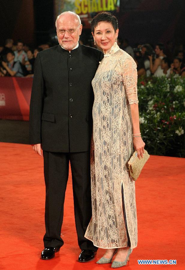 Marco Muller, president of the 68th Venice International Film Festival, and Hong Kong film producer Shi Nan-Sun arrive on the red carpet for the premiere of the Chinese Hong Kong film 'Bai She Chuan Shuo' ('The Sorcerer and the White Snake') at the 68th Venice International Film Festival in Venice, Italy, Sept. 2, 2011. [Wang Qingqin/Xinhua]