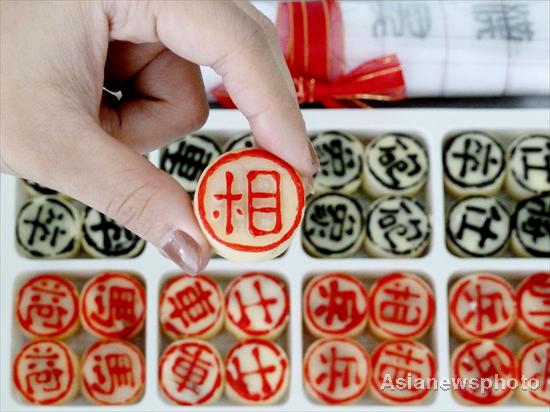 A bakery in Nanjing, South China's Jiangsu province, sells chess pieces made from mooncakes, Sept 2, 2011. 
