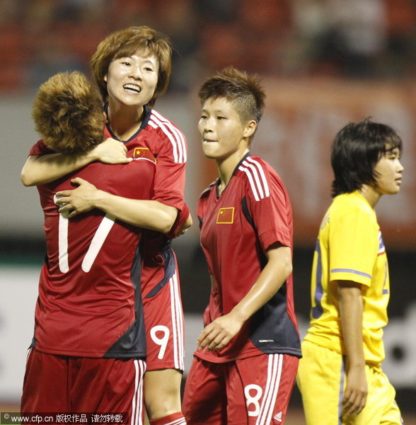 Xu Yuan of China celebrates with team-mates after scoring a goal during the London Olympic Women's Football Asian Qualifier match between China and Thailand at Shandong Sports Center on September 5, 2011 in Jinan, China.