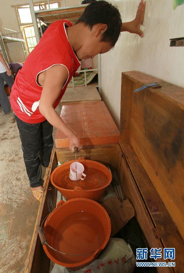 Students pour used water into a big bucket. The dirty water will be used to wash the toilets at Gengsha School in Fengshan county, South China’s Guangxi Zhuang autonomous region, Sept 7, 2011. 