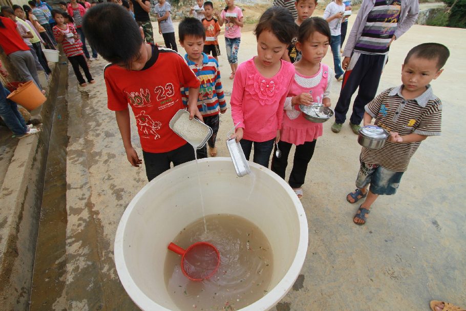 Students pour used water into a big bucket. The dirty water will be used to wash the toilets at Gengsha School in Fengshan county, South China’s Guangxi Zhuang autonomous region, Sept 7, 2011. 