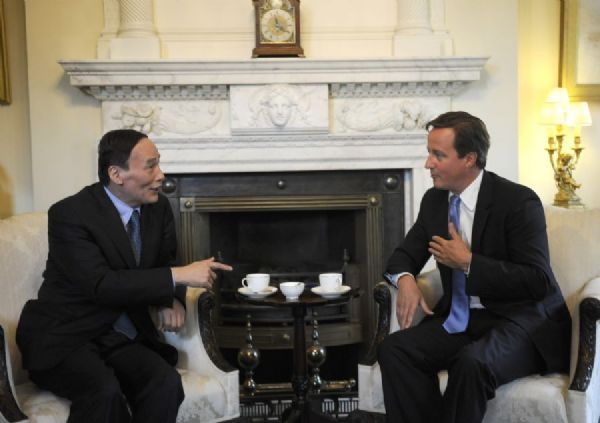 Visiting Chinese Vice Premier Wang Qishan (L) talks with British Prime Minister David Cameron in London, Britain, Sept. 8, 2011. [Zeng Yi/Xinhua] 