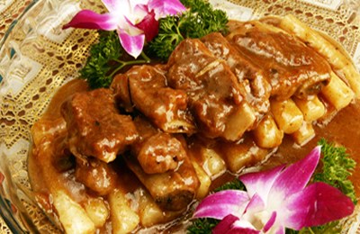 Pork ribs with fried New year cake, one of the 'top 10 most famous Shanghai snacks' by China.org.cn.