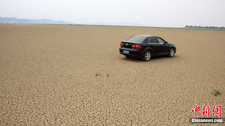 A car drives on a dry river bed on one section of Poyang Lake, China&apos;s largest fresh water lake, in Jiangxi province, on Sept. 7, 2011, after a severe drought. 