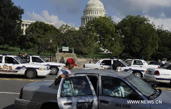 Police cars are seen in front of the Capitol Hill in Washington, capital of the United States, on Sept. 9, 2011. U.S. Homeland Security Secretary Janet Napolitano on Friday asked Americans to be vigilant against potential terror threat surrounding the 10th anniversary of the 9/11 terrorist attacks. [Xinhua/Zhang Jun]