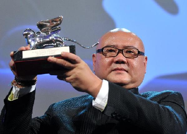 Chinese director Cai Shangjun receives the award of the Silver Lion for the Best Director for his film 'Ren Shan Ren Hai (People Mountain People Sea)' at the awarding ceremony of the 68th Venice Film Festival in Venice, Italy, Sept. 10, 2011. [Wang Qingqin/Xinhua]