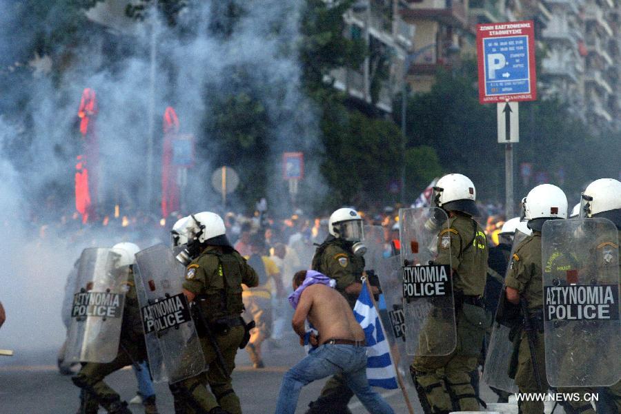 Greek protesters clash with anti riot police during a protest at the northern Greece city of Thessaloniki on Sept. 10, 2011. Thousands of demonstrators marched at the city center, as Greek Prime Minister George Papandreou delivered an economic policy speech on the first day of the 76th Thessaloniki Trade Fair, which will last until Sept. 18. [Marios Lolos/Xinhua]
