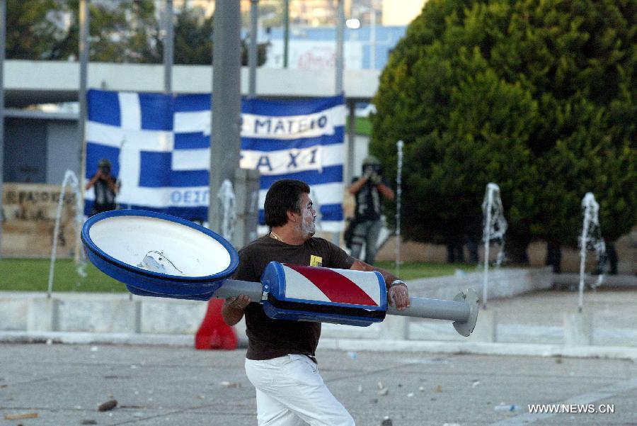 A Greek protester takes part in a protest held at the northern Greece city of Thessaloniki on Sept. 10, 2011. [Marios Lolos/Xinhua]
