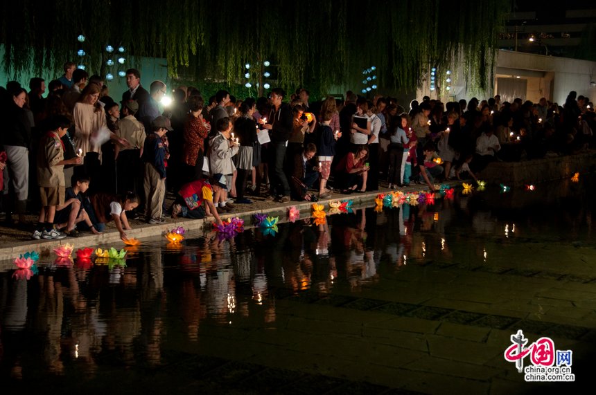 At the commemoration ceremony, people set off lotus lanterns in a pond as a means to show their emotions for the deceased lives in the 9/11 attacks. [Pierre Chen / China.org.cn]