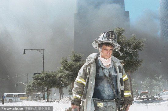 An unidentified New York City firefighter walks away from Ground Zero after the collapse of the Twin Towers September 11, 2001 in New York City. [Photo: Anthony Correia/GettyNorthAmerica/CFP] 