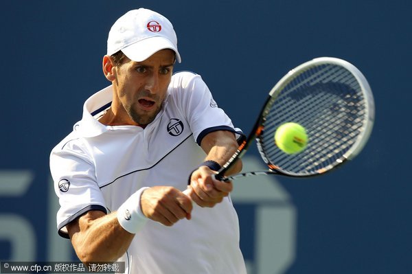 Novak Djokovic of Serbia hits a return against Rafael Nadal of Spain during the Men's Final on Day Fifteen of the 2011 US Open at the USTA Billie Jean King National Tennis Center on September 12, 2011 in the Flushing neighborhood of the Queens borough of New York City.