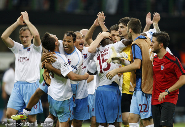 Trabzonspor soccer players celebrate after defeating 1-0 Inter Milan in a Champions League Group B soccer match at the San Siro stadium in Milan, Italy, Wednesday, Sept. 14, 2011.