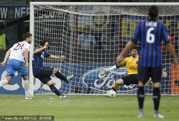 Inter Milan Argentine forward Diego Milito (second from left) tries to score as Trabzonspor goalkeeper Tolga Zengin is about to stop the ball during a champions league, Group B soccer match, between Inter Milan and Trabzonspor at the San siro stadium in Milan, Italy, Wednesday, Sept. 14, 2011. Trabzonspor won 1-0.