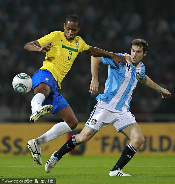 Brazil's Dede (left) controls the ball as he grabs Argentina's Mauro Boselli (right) during a friendly soccer match in Cordoba, Argentina, Wednesday, Sept. 14, 2011.