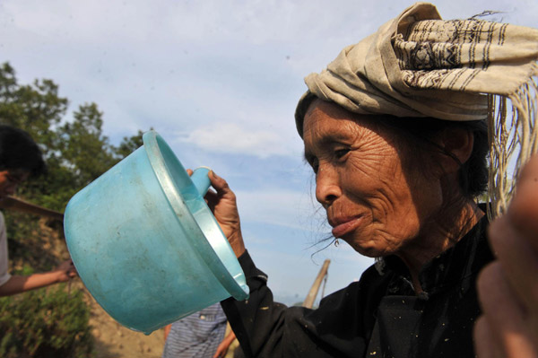 A villager drinks water in the Nahong neighborhood of Yakou village, Longlin county in Guangxi Zhuang autonomous region on Sept 15, 2011. 