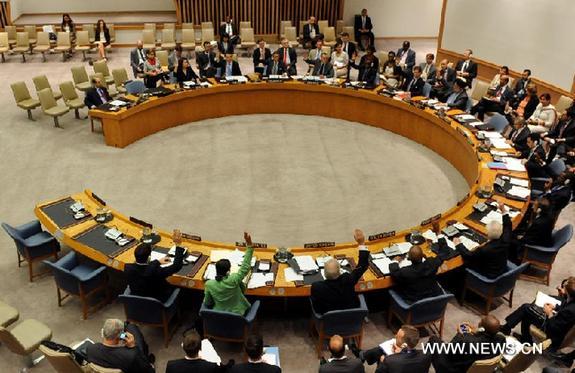 Representatives of member states of the UN Security Council vote in favor of a resolution at the UN headquarters in New York, the United States, Sept. 16, 2011. The UN Security Council on Friday unanimously adopted a resolution to ease sanctions against Libya's assets and arms. [Xinhua]