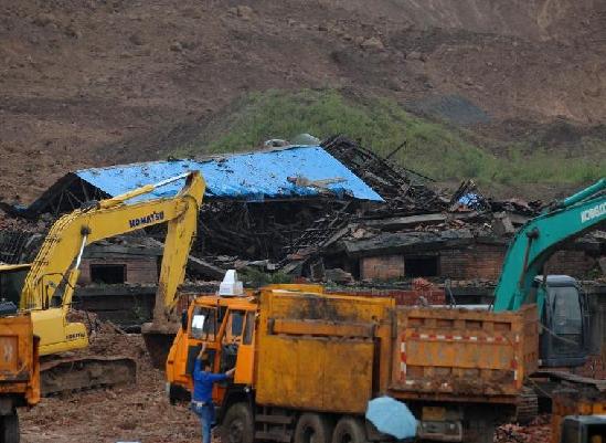 Rescuers seach for missing people at the site of a rain-triggered landslide in Xi'an, capital of northwest China's Shaanxi Province, Sept. 18, 2011. The rain-triggered landslide hit two mountain-side factories in Xi'an on Saturday, leaving at least nine workers dead and many more missing. Twenty-seven excavators and some 700 people were mobilized to rescue missing workers.