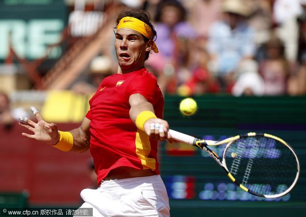Spanish player Rafael Nadal returns to French Jo-Wilfried Tsonga during their individual match of the Davis Cup semifinal Spain vs France at Los Califas bullring in Cordoba, southern Spain, September 18, 2011. Nadal won the match 6-0,6-2 and 6-4.