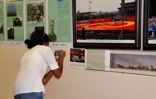 A visitor views pictures at a photo exhibition marking the 100th anniversary of the Chinese Xinhai (1911) Revolution in Orlando, the United States, Sept. 17, 2011. 