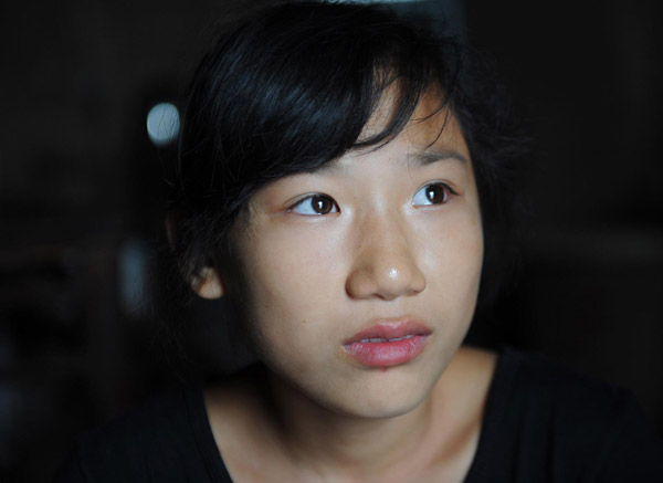 Li Chengqun, 14, tells the story of her life in a shack in Ganshui town of Qijiang county, Southwest China's Chongqing municipality on Sept 18, 2011.