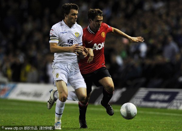 Michael Owen (R) of Manchester United is tackled by Jonathan Howson of Leeds during the Carling Cup Third Round match between Leeds United and Manchester United at Elland Road on September 20, 2011 in Leeds, England.