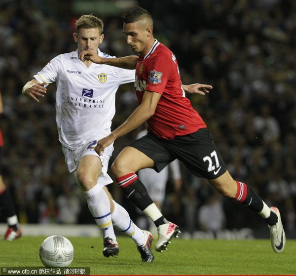 Federico Macheda of Manchester United clashes with Tom Lees of Leeds United during the Carling Cup Third Round match between Leeds United and Manchester United at Elland Road on September 20, 2011 in Leeds, England. 