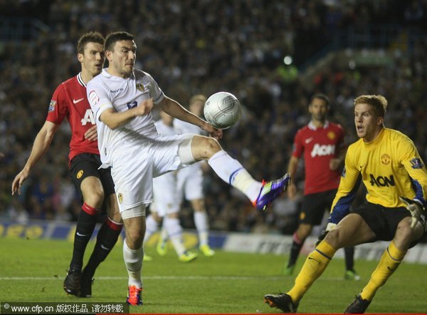 Ben Amos (R) of Manchester United clashes with Robert Snodgrass of Leeds United during the Carling Cup Third Round match between Leeds United and Manchester United at Elland Road on September 20, 2011 in Leeds, England.