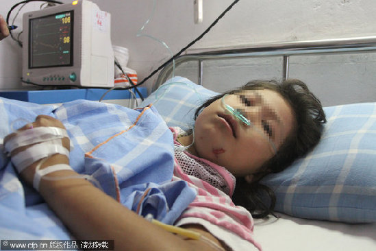 A girl is hospitalized after attempting suicide in Jiujiang, East China's Jiangxi province, Sept 19, 2011.